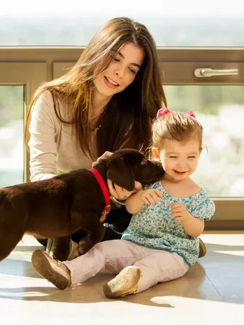 Nanny with child and dog in a warm home setting